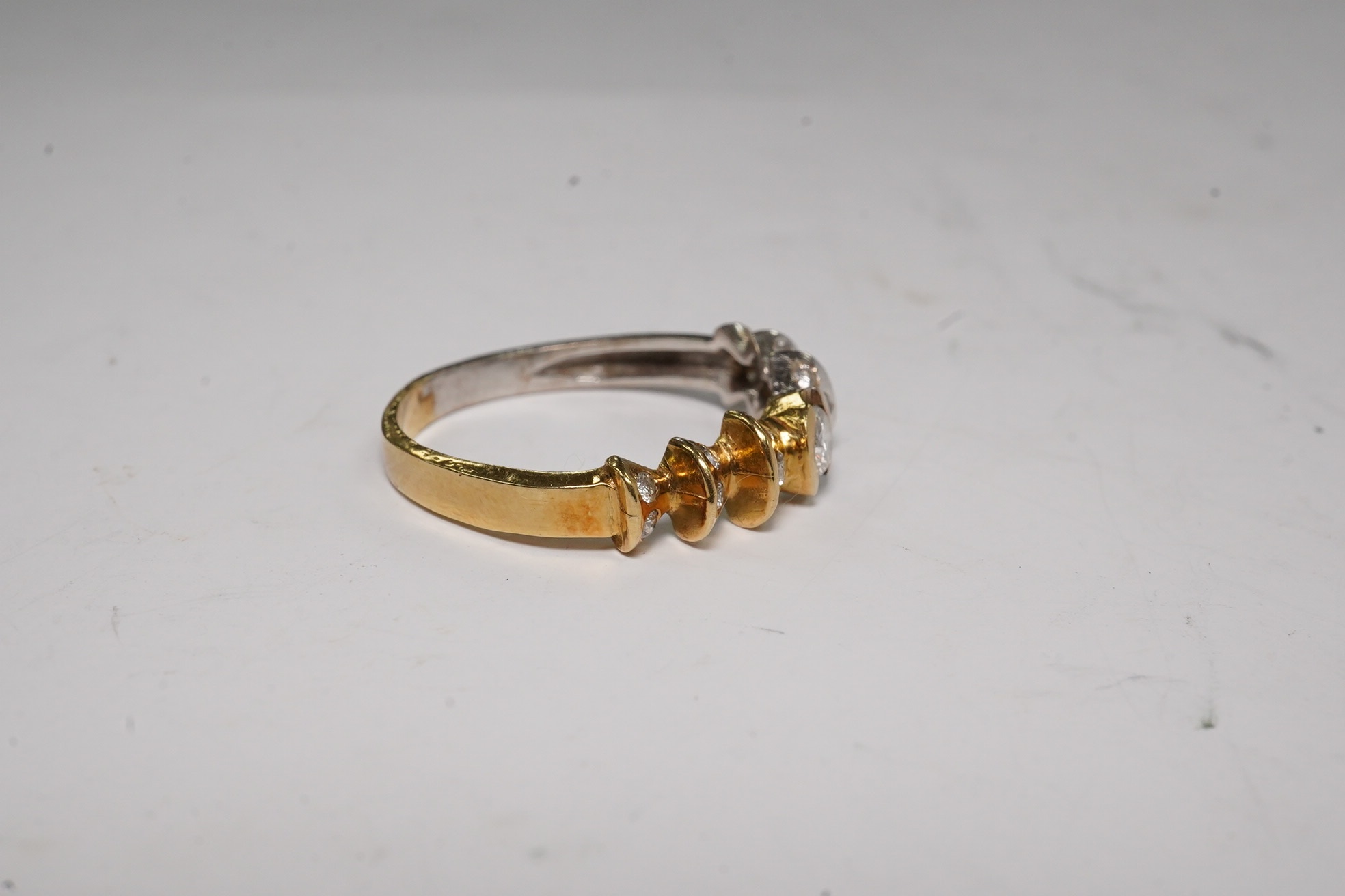 A yellow and white metal and seventeen stone diamond cluster set half hoop ring, size O/P, gross weight 3.3 grams. Condition - fair.